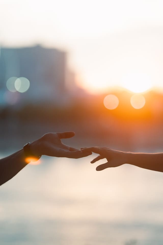 two people kindly reaching out to each other