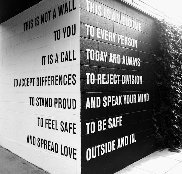 affirmations of tolerance written on a wall
