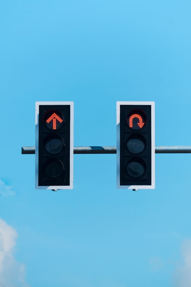 Two traffic lights on red, with different directions to decide about