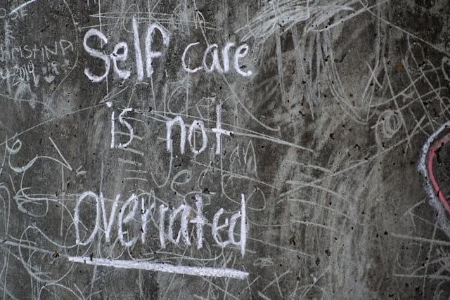Self care is not overrated written on a blackboarc