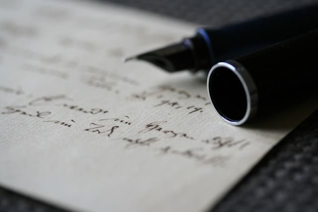 A fountain pen resting on a handwritten letter